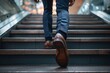 © SH Design - A man wearing brown shoes is walking up a set of stairs