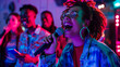 © Alina Tymofieieva - A group of friends cheers as a woman sings into a microphone, surrounded by colorful lights and an energetic atmosphere during a karaoke night.