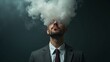 © mischenko - Male businessman in suit and tie with head full of smoke clouds made