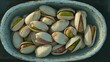 © Flowaiart - Close-up Shot of Pistachios in a Rustic Blue Bowl Captured in Natural Light