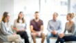 © Mari - 'Therapist and Group Session: Blurred Background' - Participants in a mental health therapy session, with a blurred background to focus on the group dynamic.