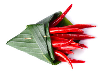 Canvas Print - Red chili peppers Wrapped in banana leaves isolated on a white background