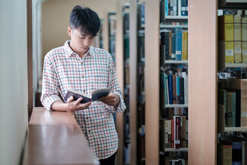 Poster - University Student Reading Book in Library