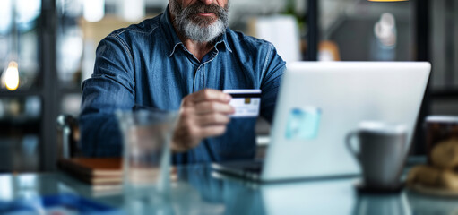  business man holding a credit card and mobile phone in an office, 