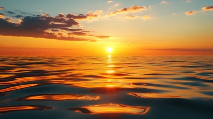 Golden sunset over a calm sea, clear weather, warm glow on the horizon