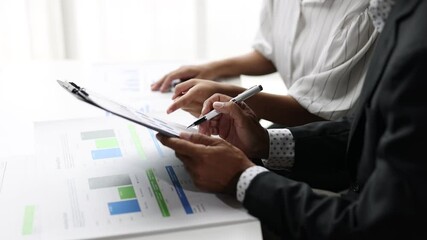 Wall Mural - Financial expert analyzing charts and graphs in a meeting. Business professional analyze financial chart and graph during a meeting, data discussion and strategic planning.