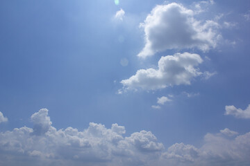 A blue sky with puffy clouds.