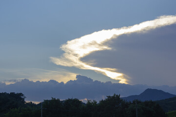Canvas Print - Mountain silhouette and glowing clouds