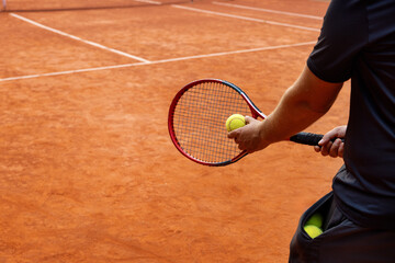 Wall Mural - tennis player on outdoor clay court ready to serve the ball. copy space