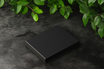 Wall Mural - Mockup of a black minimal business card on a black table corner with leaves and a light. PSD file included.