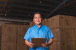 © Mdv Edwards - Middle aged Asian warehouse clerk organizing inventory in storage facility
