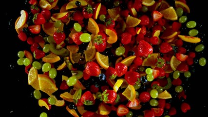 Fototapete - Super Slow Motion of Flying Fruit Up in the Air, Top View. Filmed on High Speed Cinema Camera, 1000 fps. Isolated on Black Background.
