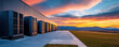 © khonkangrua - A sleek, modern data center exterior set against a vibrant sunset, with mountains in the background and expansive landscape.