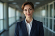© Amir Bajric - Portrait of a professional woman in a suit. Business woman standing in an office