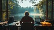 © Nottenaj - A writer engrossed in their work at a desk overlooking a tranquil lake, finding inspiration in the natural surroundings.