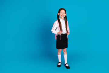 Poster - Full body portrait of little schoolchild empty space wear uniform isolated on blue color background