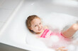 © BartLoveyou - girl playing with water and foam in bath