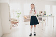 © deagreez - Portrait of lovely little schoolchild crossed arms wear uniform living room flat indoors