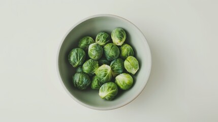 Sticker - A clean, minimalistic top view of a light gray bowl filled with Brussels sprouts.