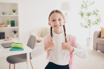 Wall Mural - Portrait of lovely little schoolchild thumb up wear uniform living room flat indoors