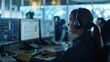 © VK Studio - People working in a control room with multiple screens, showcasing a professional environment focused on monitoring and data analysis.
