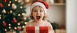 © Jirapron - A closeup of a child s excited face as they open a Christmas gift, with a warmly lit tree in the background christmas background family warmth concept.