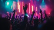 © Yeivaz - Crowd raising their hands on a background of colorful neon stage lights of a music festival