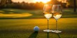 © andyaziz6 - Golf Course Sunset with Two Wine Glasses and a Golf Ball