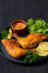 Sticker - fried chicken legs with lettuce, lemon on plate