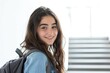 © Ева Поликарпова - A smiling young girl carries a backpack and poses for the camera, ready for an adventure