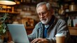 © bird_saranyoo - A Senior man attending online class using laptop By staying active and connected.