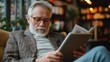 © bird_saranyoo - Senior man reads digital newspaper on tablet Stay informed and engage with the world through modern technology.