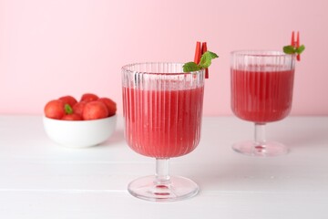 Wall Mural - Tasty watermelon drink in glasses and fresh fruit on white wooden table