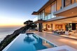 © dekreatif - Modern house with infinity pool overlooking the ocean at sunset.