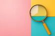 © tonstock - Top view of a magnifying glass on colorful geometric background, symbolizing the concept of searching, focus, and discovery in a vibrant composition.