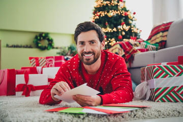 Sticker - Photo of nice young man ugly sweater hold envelope christmas atmosphere apartment indoors