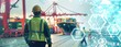 © YURIMA - Logistics professionals in high-visibility vests and helmets oversee container operations at a port, with digital interface overlays highlighting advanced supply chain management technology.