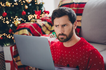 Canvas Print - Photo of nice young man thimk use laptop ugly sweater christmas atmosphere apartment indoors