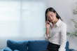 © Tj - Asian businesswomen working in the office talking the phone, and checking the report