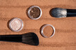 © ADDICTIVE STOCK - Top view of makeup brushes and loose powder cosmetics
