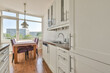 © ADDICTIVE STOCK - Modern kitchen interior with dining area and city view