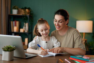 Wall Mural - Girl doing homework or online education.