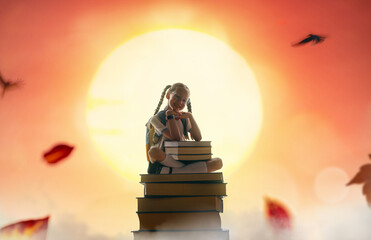 Wall Mural - child on the tower of books