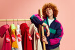 © Lustre Art Group  - Chill and ready for sales, stylish shopper leans against rack of vibrant, discount-tagged clothes, eyeing best deals against pink background. Concept of Black Friday, Cyber Monday, fashion, Flash Sale