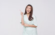 © NaMong Productions - Young Asian woman wearing patient outfits pointing finger presenting to copy space for product isolated on white background. advertisement life insurance
