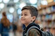 © Alina - School boy with backpack on blurred classroom background