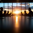 © Jammy - Silhouetted business professionals in a meeting room during sunset, highlighting teamwork and collaboration against a stunning backdrop.