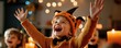 © kissbeetle - A joyful child in a pumpkin hat celebrates Halloween, surrounded by festive decorations and glowing candles, radiating happiness.