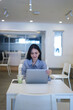 © aratrastudio - Businesswoman works at laptop waving hello having video call with client at office Remote job