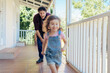 © Marko Geber - Father playing with daughter on porch